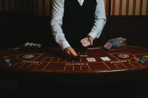 Croupier displaying cards on the table at a casino