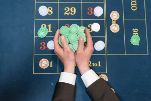 Two hands taking roulette chips