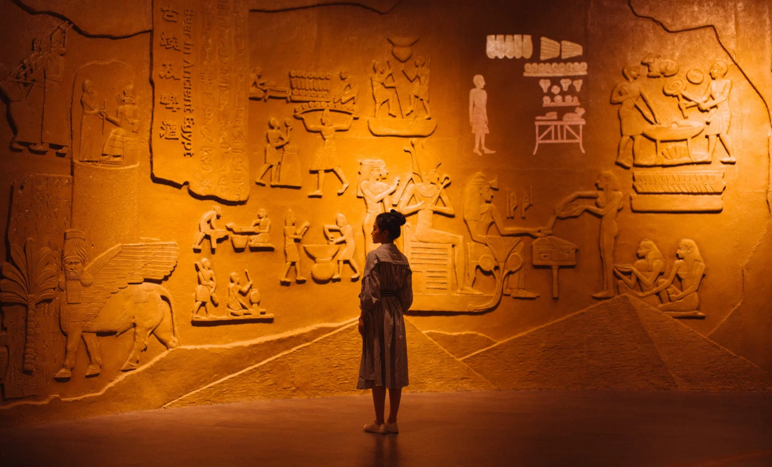 Woman looking at ancient wall paintings